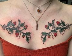 a woman's chest with flowers and leaves on it