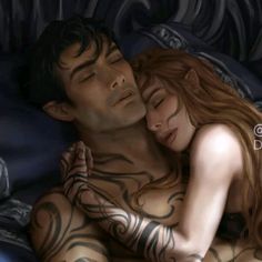 a man and woman laying in bed with tattoos on their bodies, one is hugging the other