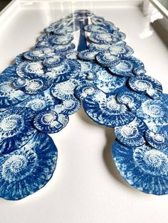 blue and white plates are arranged in a row on a tray, with one being cut into smaller pieces