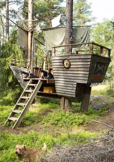 there is a boat that has been built in the woods with stairs leading up to it