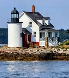 a white house sitting on top of a body of water