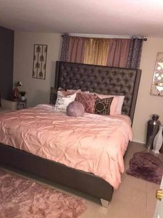 a bedroom with a large bed and pink comforter