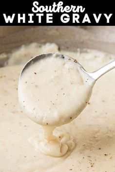 a spoon full of white gravy being stirred