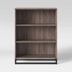 an empty bookcase with three shelves on one side and the other end open to show it