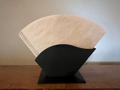 a black and white sculpture sitting on top of a wooden table