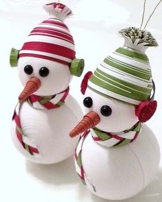 two snowmen wearing hats and scarfs made out of paper mache ornament