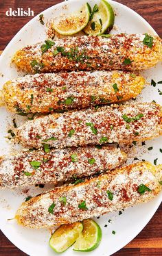 grilled corn on the cob topped with parmesan cheese and lime slices