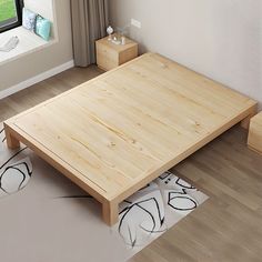 a wooden bed frame sitting on top of a hard wood floor next to a window