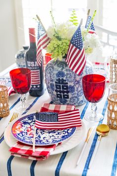 a patriotic table setting with red, white and blue plates