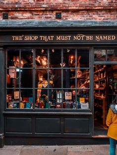 the shop that must not be named is located on the side of the street in front of an old brick building