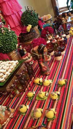 a table with many different types of food on it, including cookies and other treats