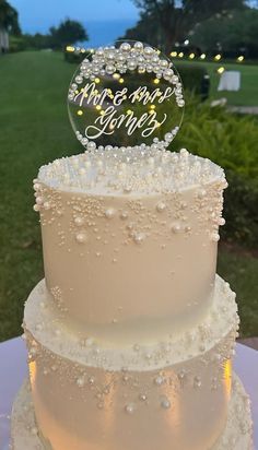 a three tiered wedding cake sitting on top of a table