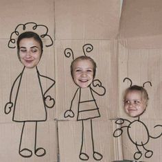 three cardboard cutouts of children's faces with hearts on them, and an image of a woman in the middle