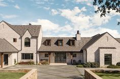 a large white brick house with lots of windows