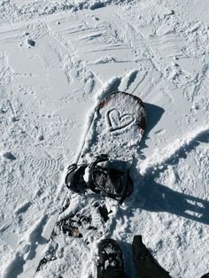 someone is standing in the snow with their feet up