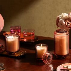 some candles are sitting on a wooden table