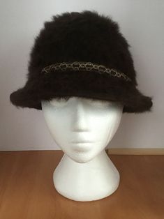 Tyrolean Alpine Hat. A stylish and easy to wear brown fluffy felt hat. Has a round, solid top and a brown and gold trim around. Make a fashion statement with this accessory. Perfect for adding a pop of fashion to your winter wear. Makes a great gift or treat yourself. Measures 21 inch inner circumference. Does not stretch. Made it Italy. Very good condition. Please see photos. 2021-12 Chic Brown Winter Hats, Chic Brown Felt Hat For Winter, Brown Fur Felt Cloche Hat, Brown Cloche Felt Hat For Winter, Brown Cloche Hat For Fall, Brown Fur Felt Hat Bands For Winter, Winter Brown Fur Felt Hat Band, Brown Brimmed Cloche Hat For Winter, Gold Fedora Hat For Winter