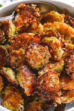 a bowl filled with cooked brussel sprouts and topped with parmesan cheese