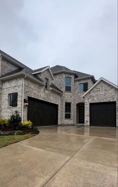 a large house with two garages and three windows