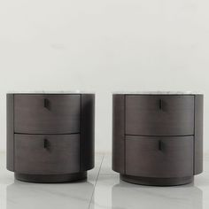 two black and white nightstands with marble top in an empty room, one on the floor