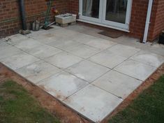 an outdoor patio being built with cement and brickwork on the ground next to it