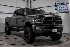 a large black truck parked in a garage