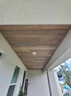 the ceiling is made from wood planks and has a light fixture on it's side