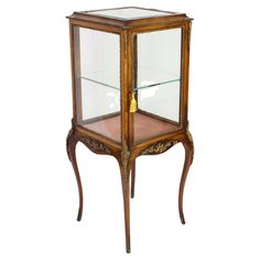 an old wooden display case with glass shelves on the top and bottom, sitting against a white background