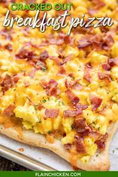 a close up of a pizza on a pan with the words cracked out breakfast pizza