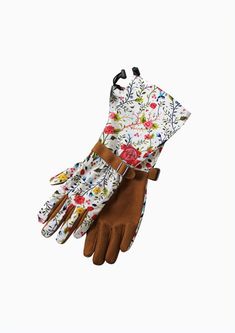 a pair of gloves with floral print on the wrist and brown leather cuffs, one in