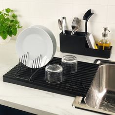 a kitchen counter with dishes and utensils on it