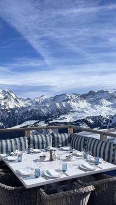 an outdoor dining area with mountain views in the backgroung and blue sky