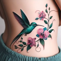 a woman's stomach with flowers and a hummingbird on it