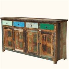 an old wooden sideboard with four drawers and two doors on the front, painted blue green and yellow