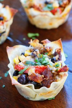 small cups filled with food sitting on top of a wooden table