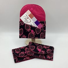 a pink and black bag with fruit on it