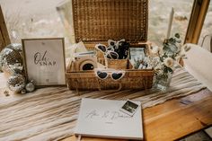 a wooden table topped with a basket filled with items