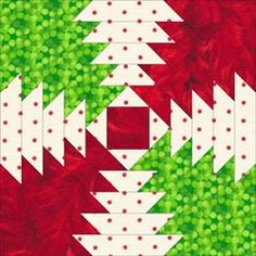 a red and green quilt with white strips on it's edges, in the shape of a christmas tree