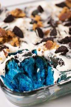 an ice cream dessert in a glass dish with cookies and oreo chips on top