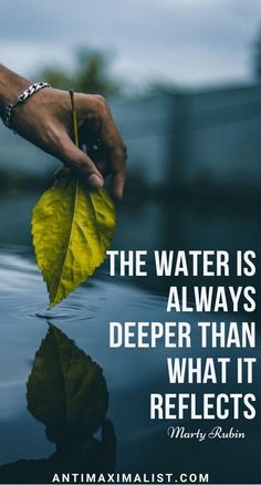 a person's hand holding a yellow leaf with the words, the water is always deeper than what it reflects