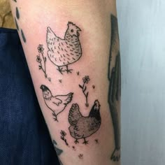 a chicken and hen tattoo on the arm