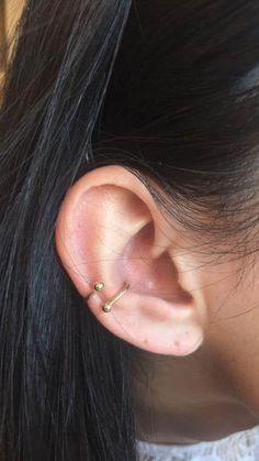 a close up of a person wearing an ear piercing