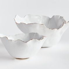 three white bowls sitting on top of each other