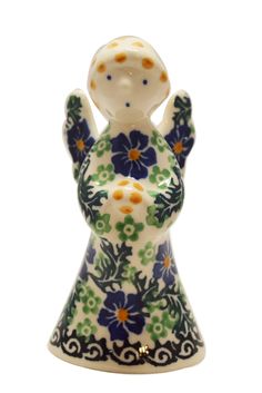 a ceramic figurine with blue and green flowers on it's body, standing in front of a white background