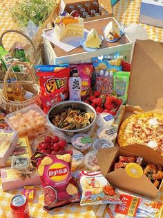 a table topped with lots of food next to boxes filled with cheese and other foods