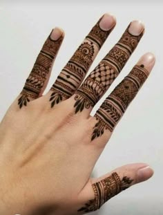 someones hand with henna tattoos on it and the fingers are in full view