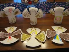 paper plates are arranged in the shape of angel wings on a table with other decorations