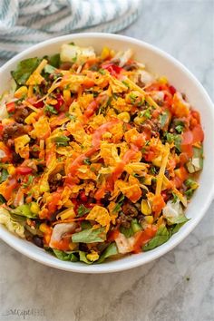 a white bowl filled with salad on top of a table