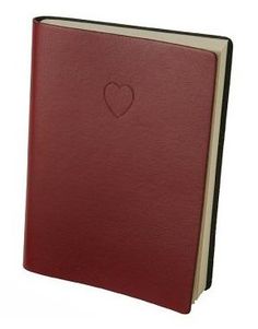 a red leather book with a heart on the front and bottom cover is open to show an empty page