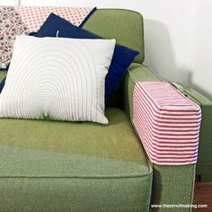 a green couch with colorful pillows on it